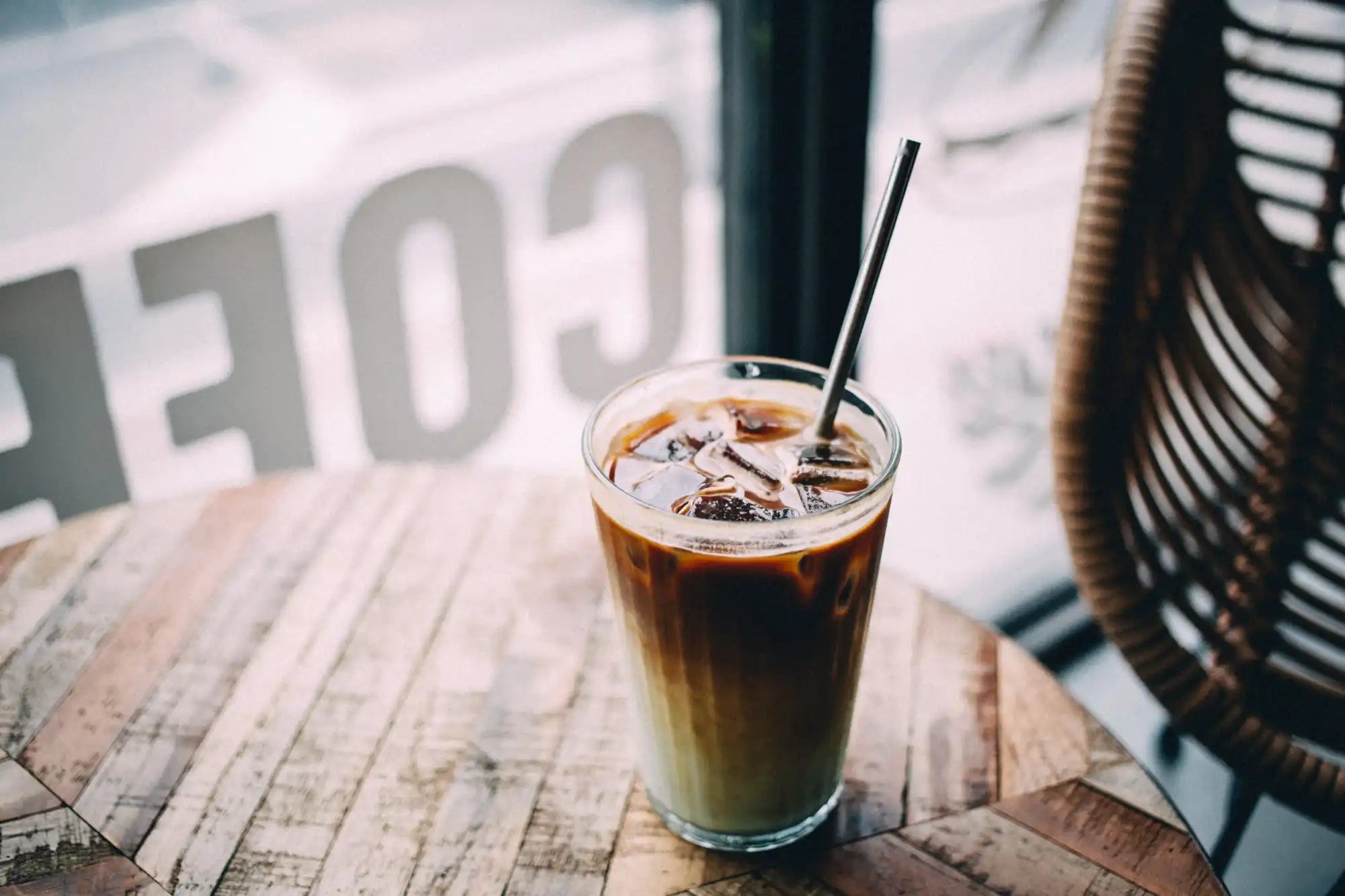 Iced coffee with metal straw.